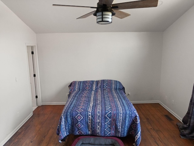 bedroom with ceiling fan and dark hardwood / wood-style flooring