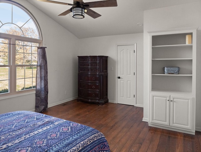 bedroom with ceiling fan, dark hardwood / wood-style flooring, and lofted ceiling