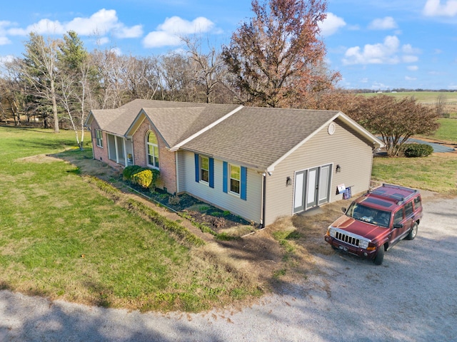 ranch-style home featuring a front lawn