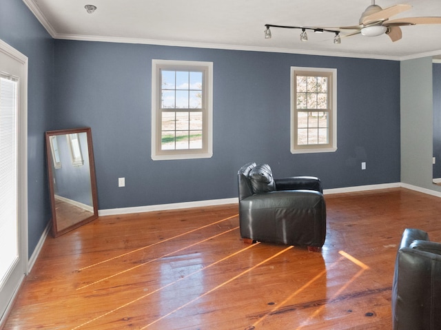 sitting room with ceiling fan, hardwood / wood-style floors, ornamental molding, and track lighting