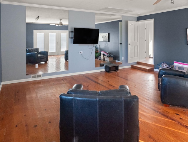 living room featuring french doors, ceiling fan, crown molding, and wood-type flooring