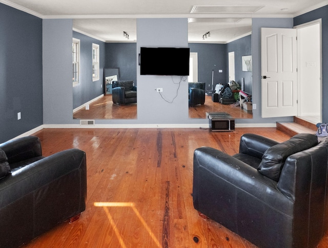 living room featuring wood-type flooring and crown molding