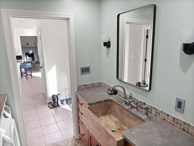 bathroom with backsplash, tile patterned floors, and vanity