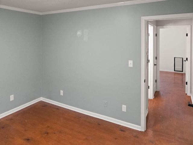 spare room featuring wood-type flooring and ornamental molding