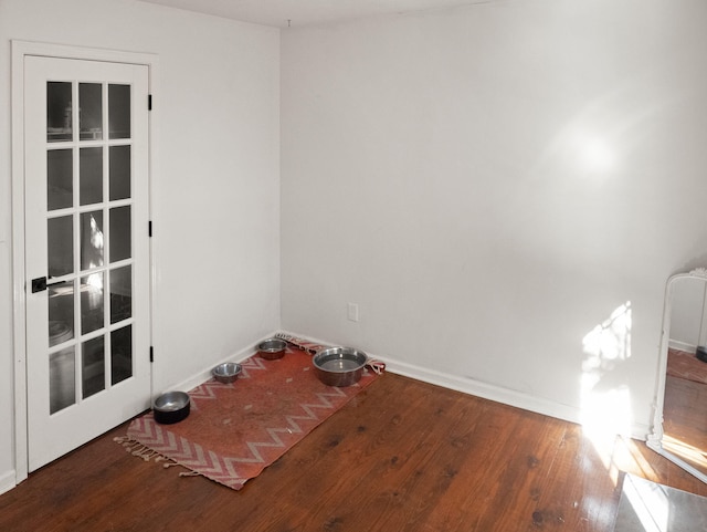 unfurnished room with wood-type flooring