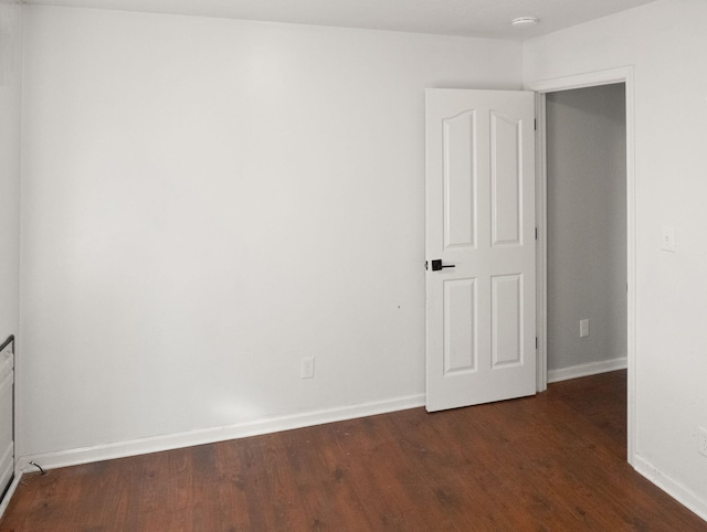 unfurnished room featuring dark hardwood / wood-style flooring