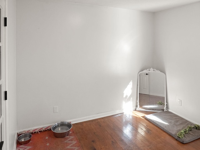 unfurnished room with hardwood / wood-style flooring