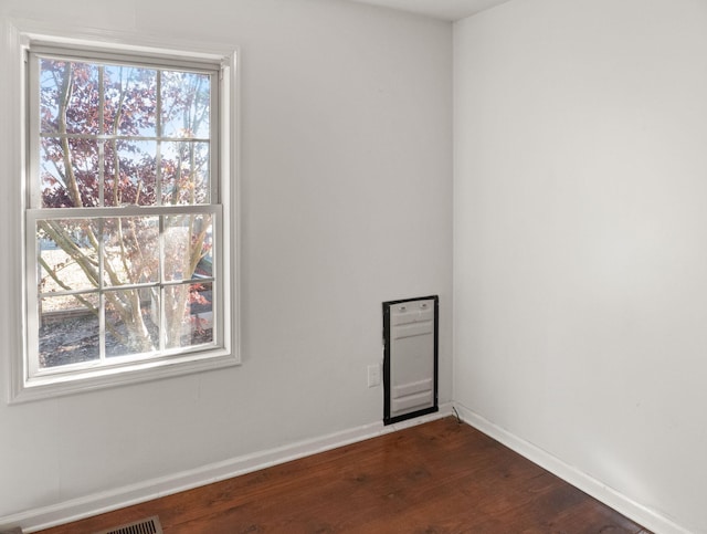 spare room with dark hardwood / wood-style flooring