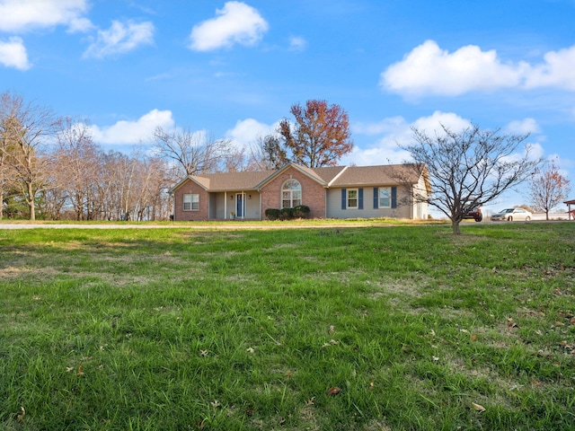 ranch-style home featuring a front yard