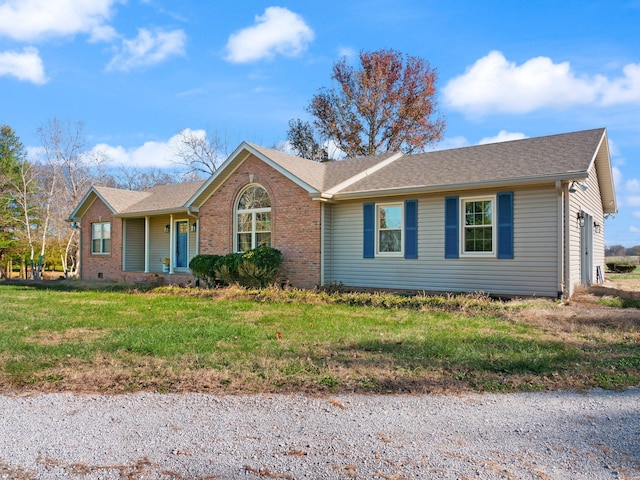 ranch-style home featuring a front yard