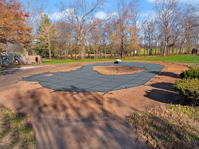 view of swimming pool featuring a storage shed and a patio