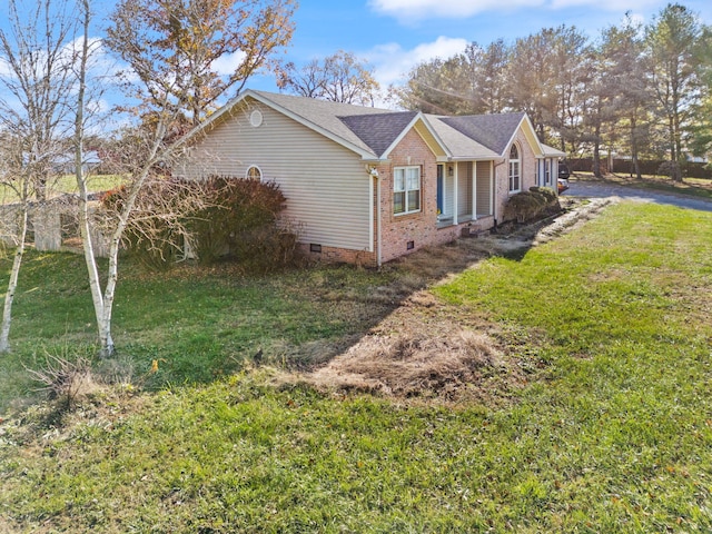 view of side of property with a yard