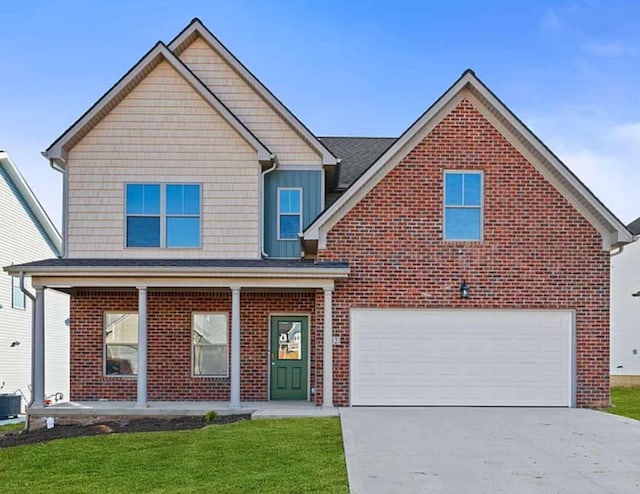 traditional-style house with brick siding, covered porch, concrete driveway, and a front yard