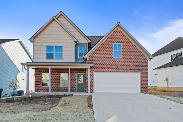 traditional-style home with driveway, a garage, central air condition unit, a porch, and brick siding