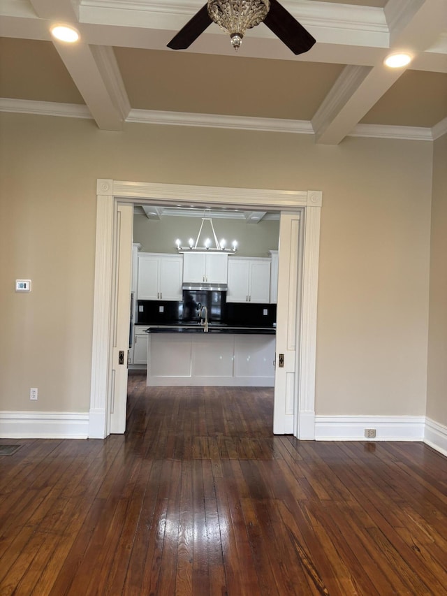 hallway featuring beamed ceiling, sink, ornamental molding, and dark wood-type flooring