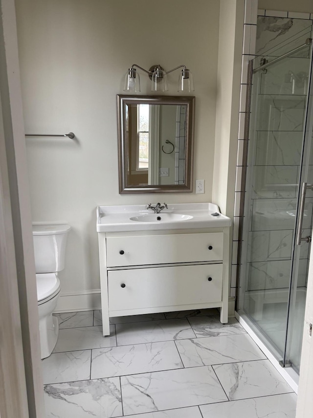 bathroom featuring vanity, toilet, and a shower with shower door