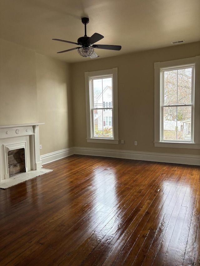 unfurnished living room with dark hardwood / wood-style floors and ceiling fan