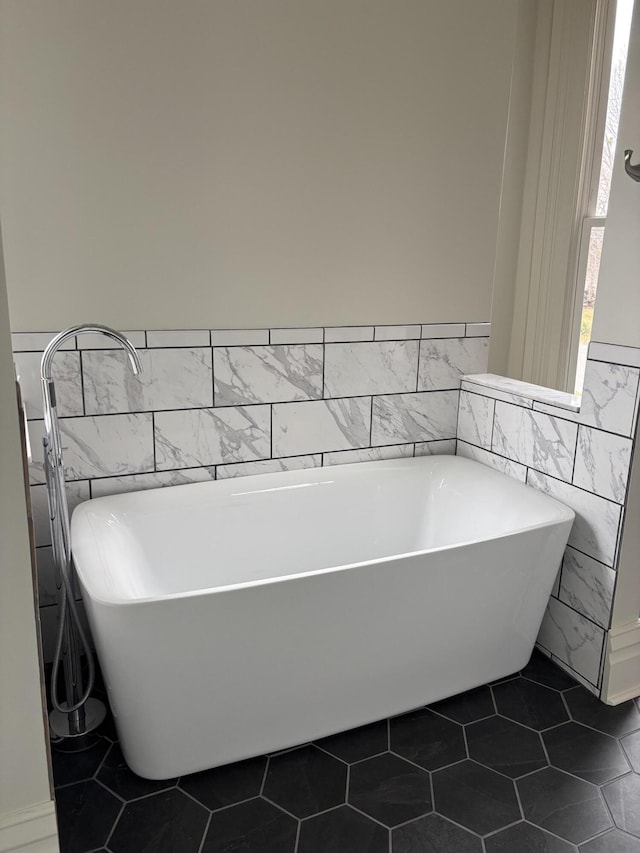 bathroom featuring tile patterned flooring and a tub