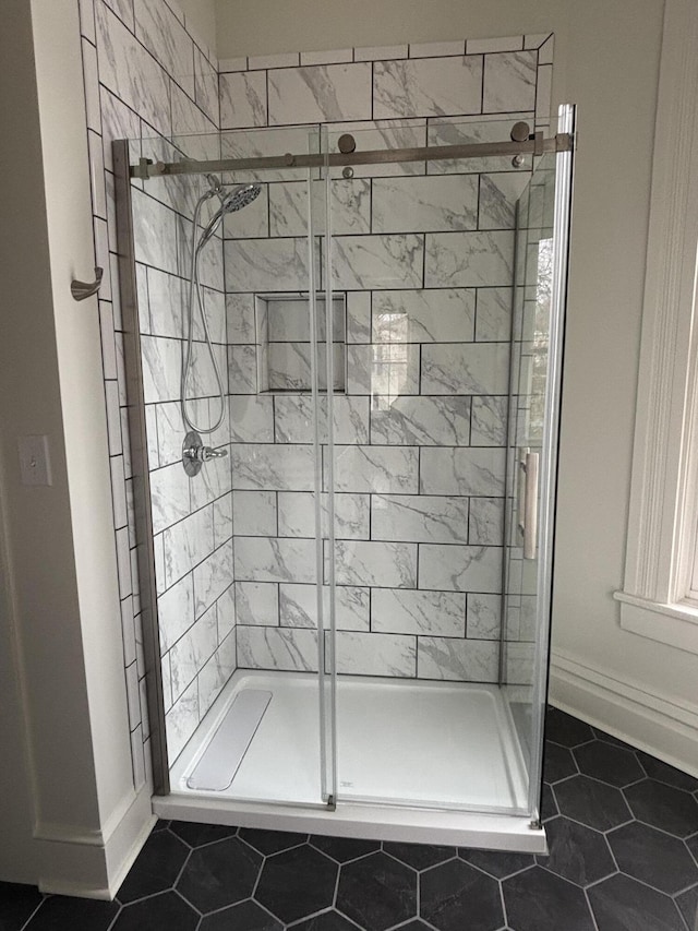 bathroom with tile patterned floors and walk in shower