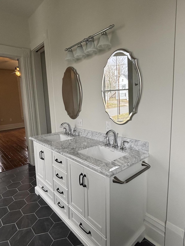 bathroom with tile patterned floors, ceiling fan, and vanity