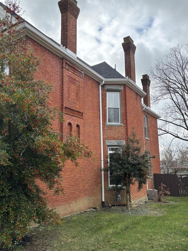 rear view of house featuring a lawn