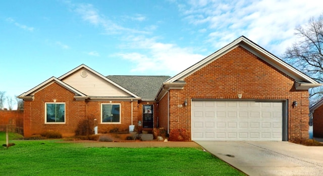 view of front facade with a front yard and a garage