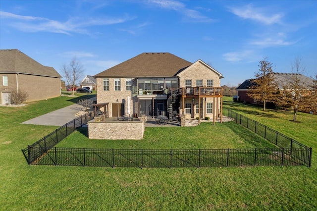 back of property with a patio area, a yard, and a wooden deck