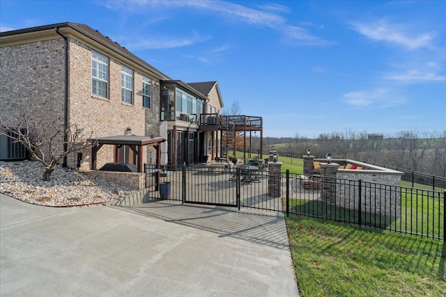 view of gate featuring a lawn and a deck