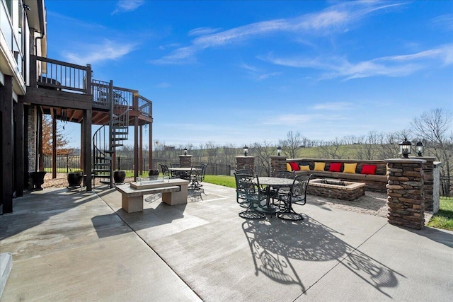 view of patio / terrace with an outdoor fire pit and a wooden deck