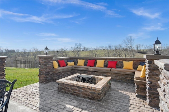 view of patio featuring an outdoor living space with a fire pit