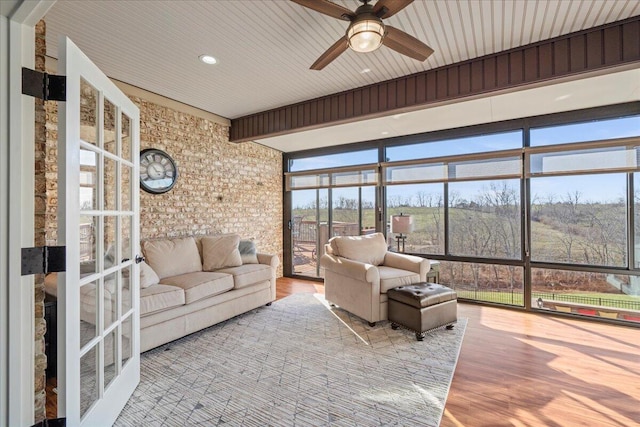 sunroom featuring ceiling fan