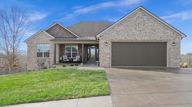 view of front of property with a porch, a garage, and a front yard