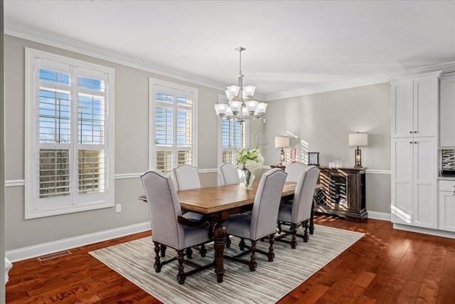 dining space with a chandelier, dark hardwood / wood-style flooring, and ornamental molding