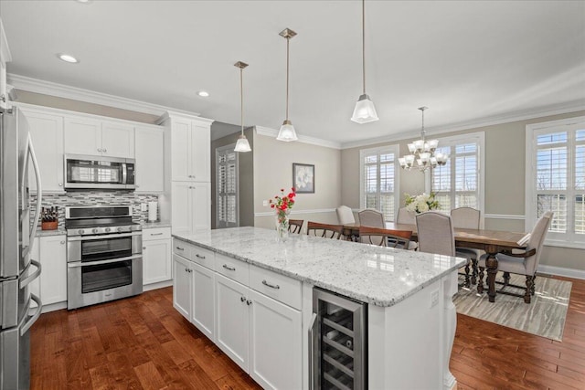 kitchen with wine cooler, pendant lighting, white cabinets, and stainless steel appliances