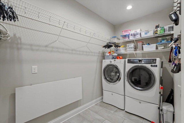 washroom featuring independent washer and dryer and light tile patterned flooring