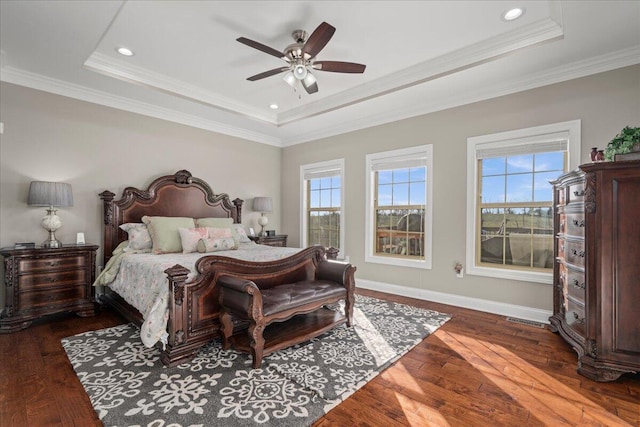 bedroom with a raised ceiling, ceiling fan, and dark hardwood / wood-style flooring