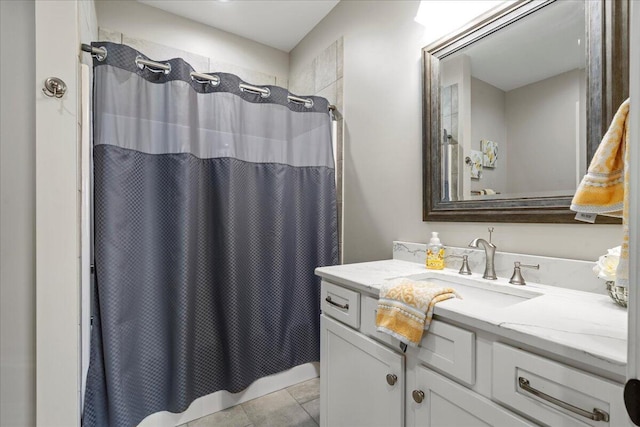 bathroom with tile patterned floors, vanity, and walk in shower