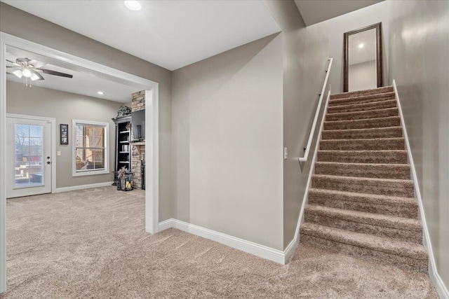 stairs with carpet and ceiling fan