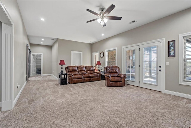 living room featuring light carpet and ceiling fan