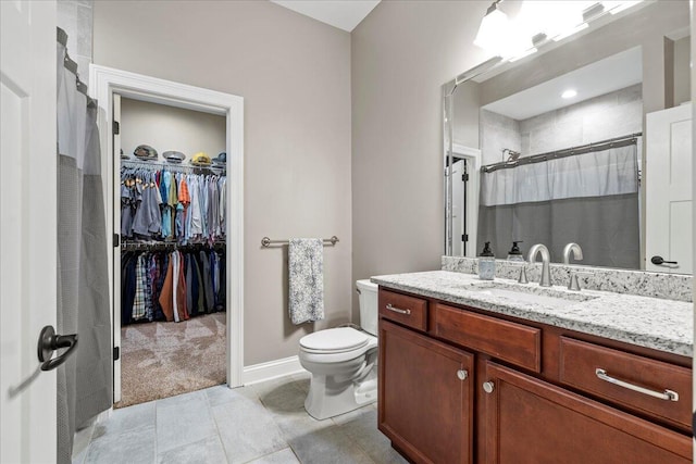 bathroom featuring vanity, toilet, and walk in shower