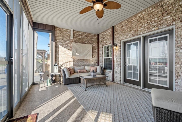 sunroom featuring ceiling fan