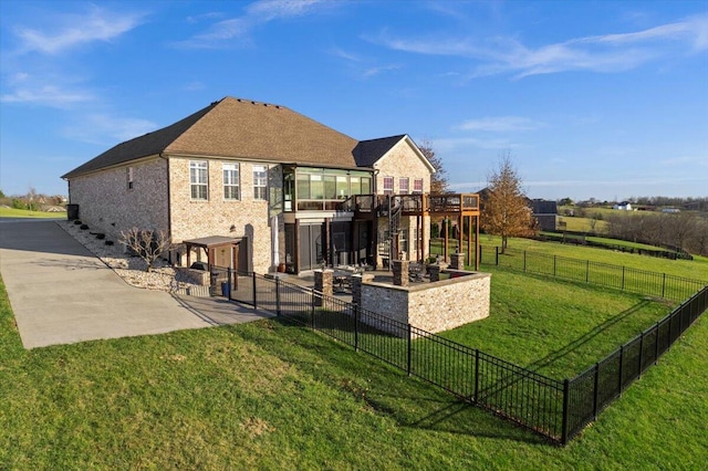 rear view of property with a yard, a patio, and a wooden deck