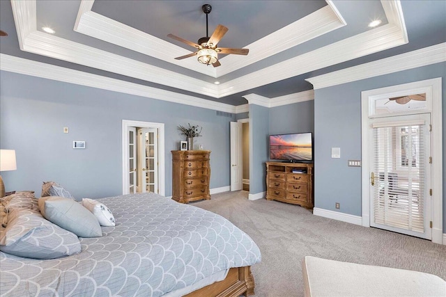 bedroom with ceiling fan, a raised ceiling, and ornamental molding