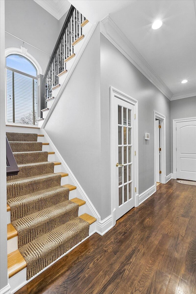 staircase with hardwood / wood-style flooring and crown molding