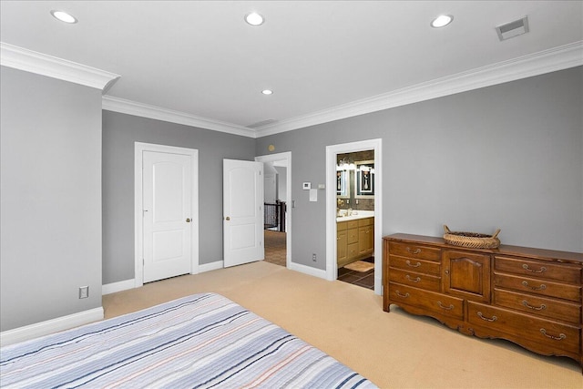 carpeted bedroom featuring ensuite bath and ornamental molding