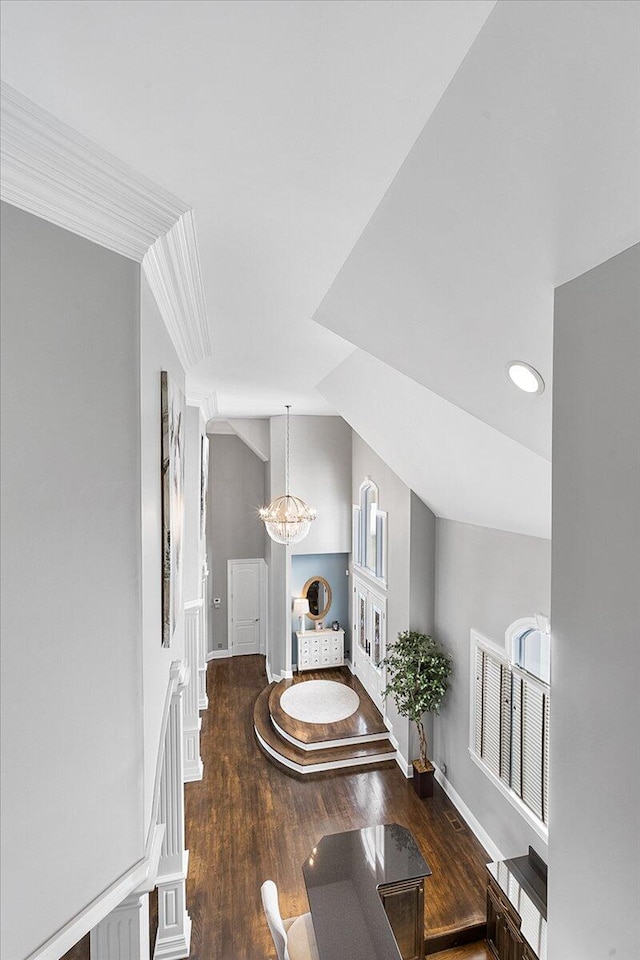 interior space with a chandelier, hardwood / wood-style flooring, and crown molding