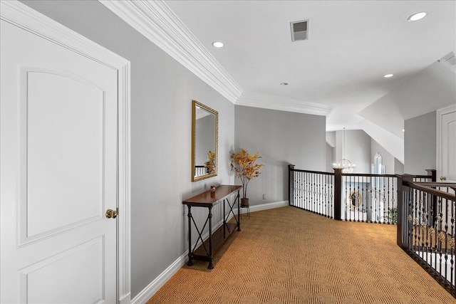 corridor with carpet floors, ornamental molding, and a chandelier