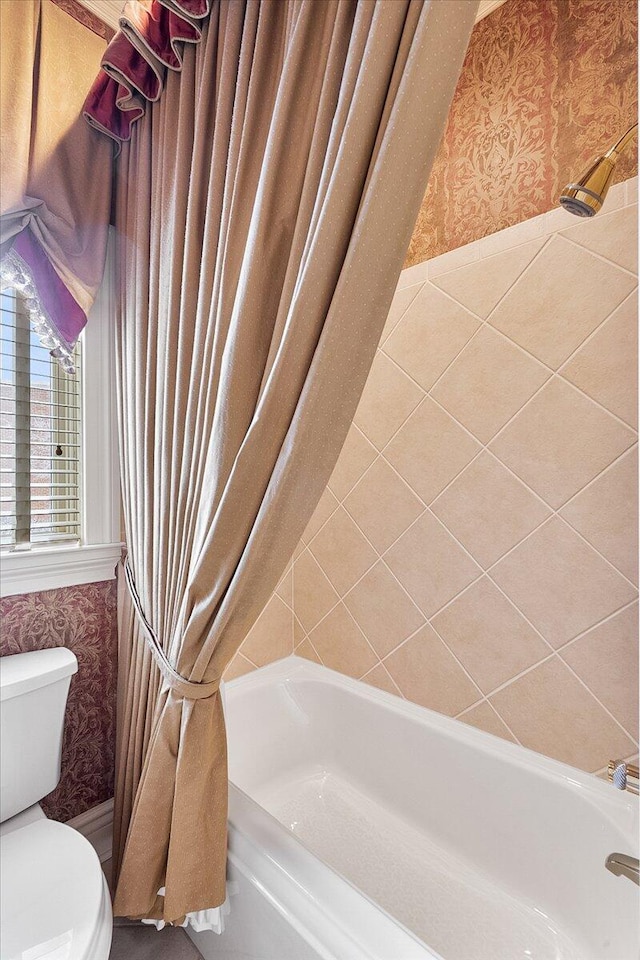 bathroom with toilet and shower / tub combo with curtain