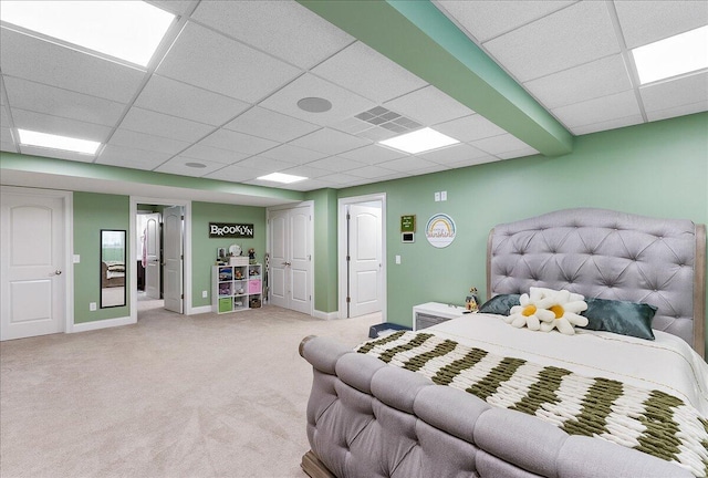 carpeted bedroom with a paneled ceiling