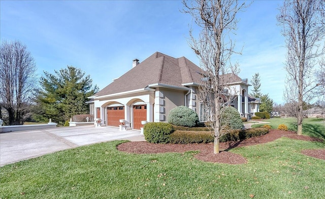 view of side of property featuring a garage and a yard